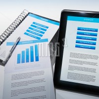 Business Plan presentation displayed on tablet and printed document.